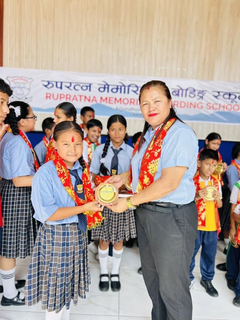 Student receiving an award at Rupratna Memorial